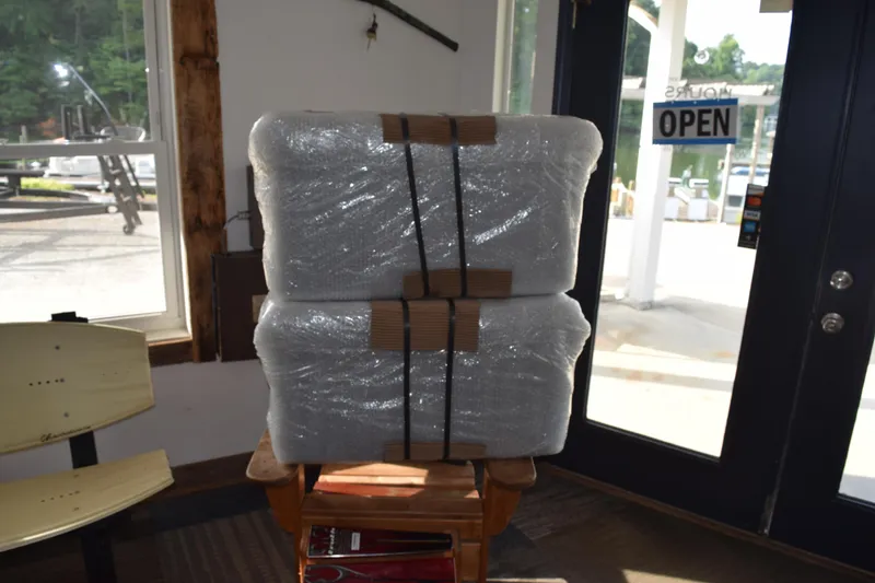 Slide: The Image of Wrapped packages inside a store with an "Open" sign on the door. - 20