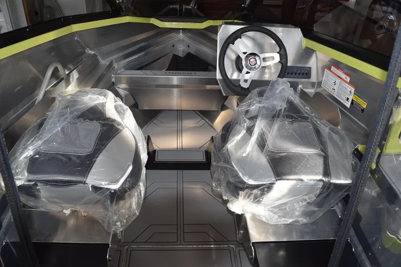 Slide: The Image of 2026 Stabicraft 1550 Fisher Offshore interior with modern seating and steering wheel. - 4