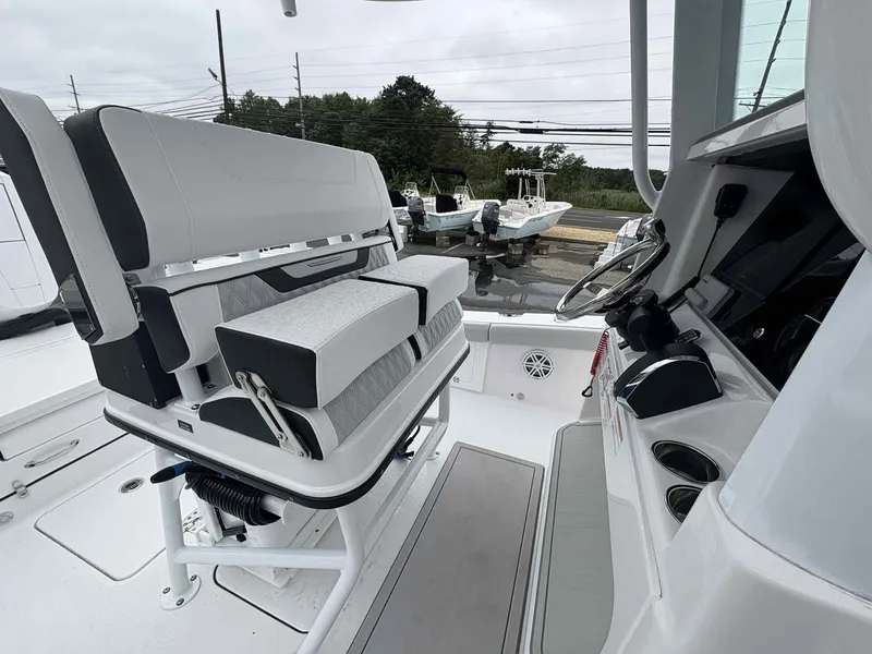 Slide: The Image of 2026 Blackfin 262 HB boat interior with modern seating and steering console. - 11