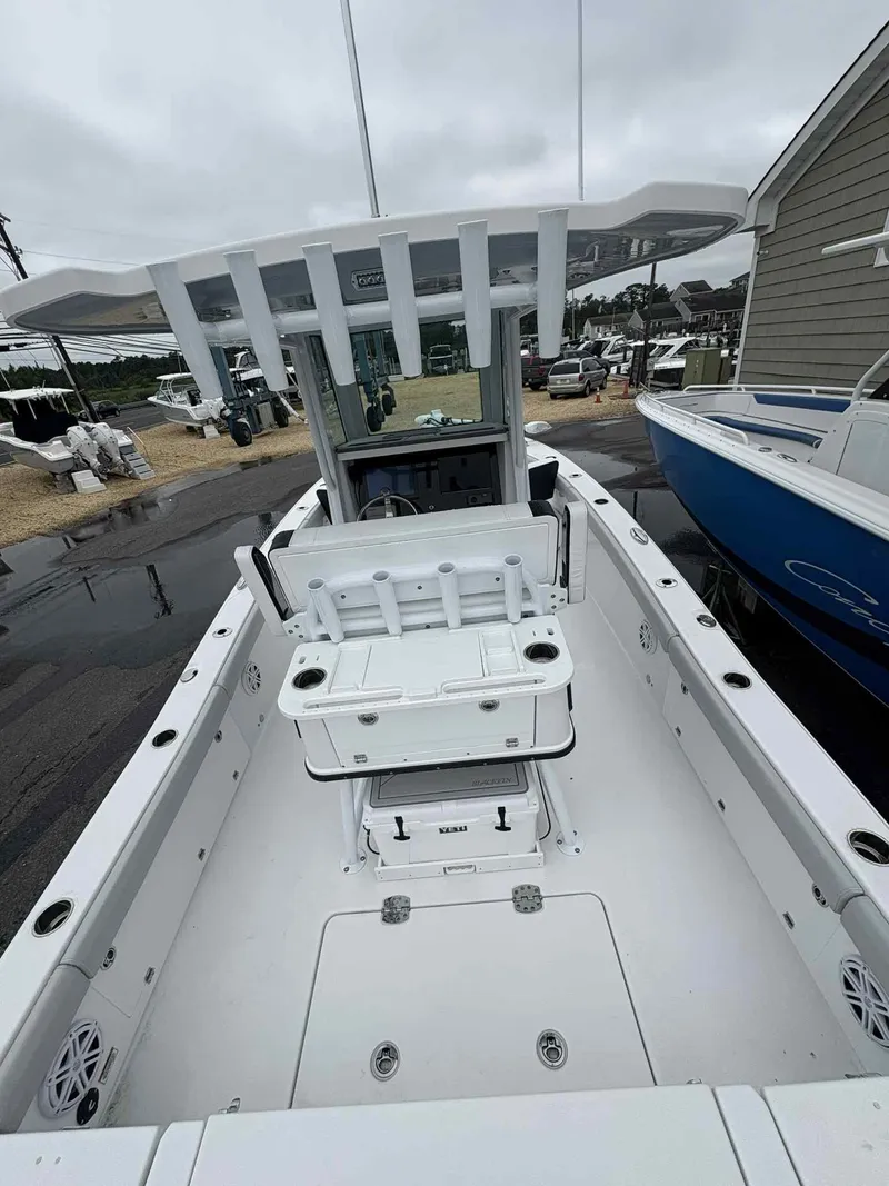 Slide: The Image of 2026 Blackfin 262 HB boat interior with seating and storage, docked outdoors. - 14