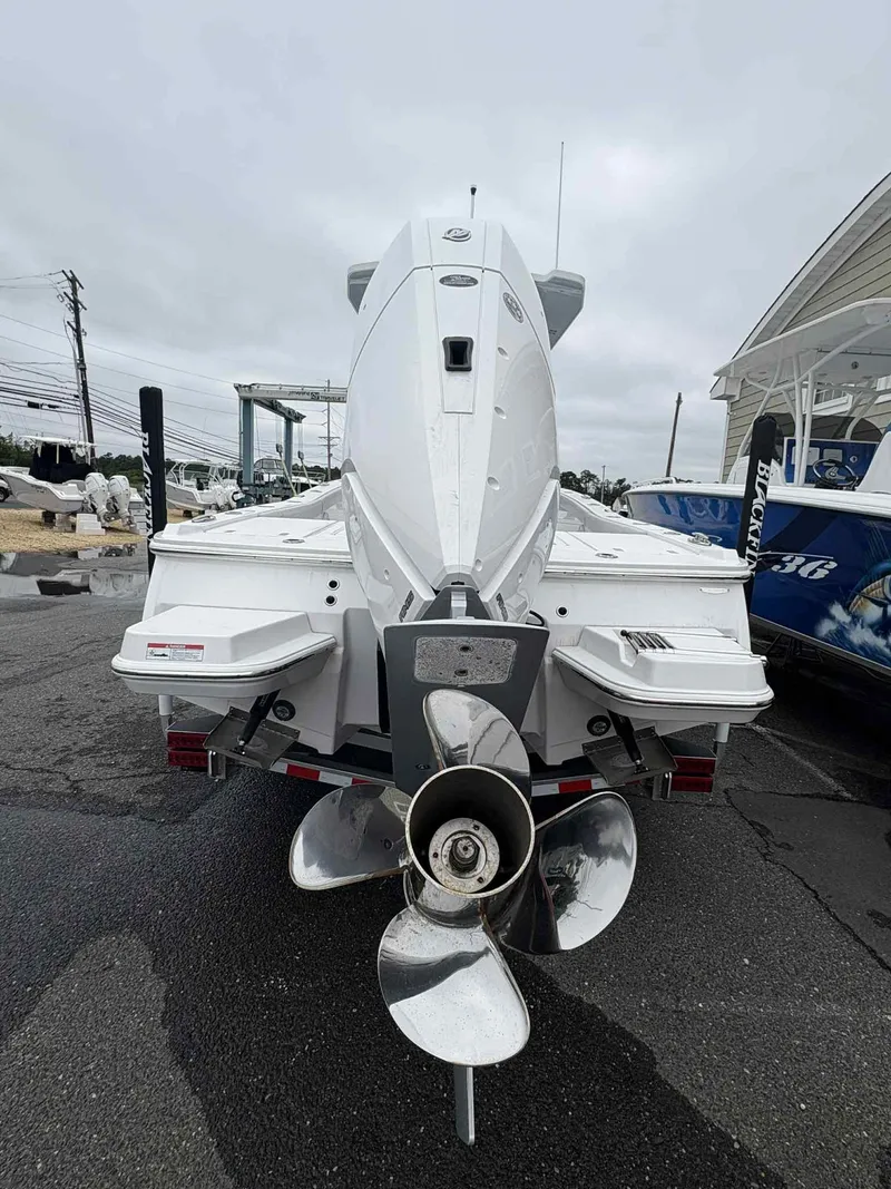 Slide: The Image of 2026 Blackfin 262 HB boat rear view with propeller, parked on a trailer. - 16