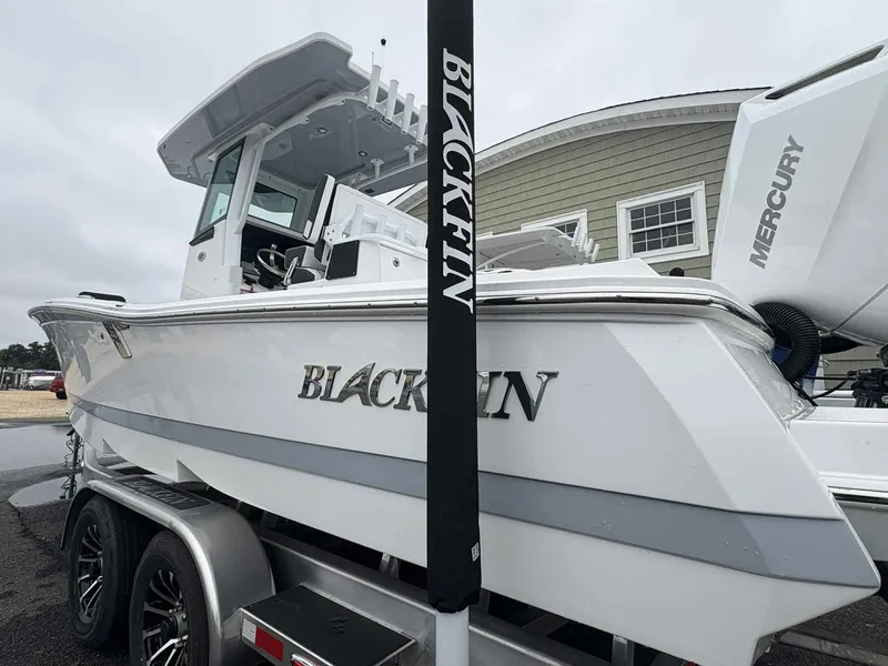 Slide: The Image of 2026 Blackfin 262 HB boat on trailer, featuring sleek design and Mercury engine. - 18