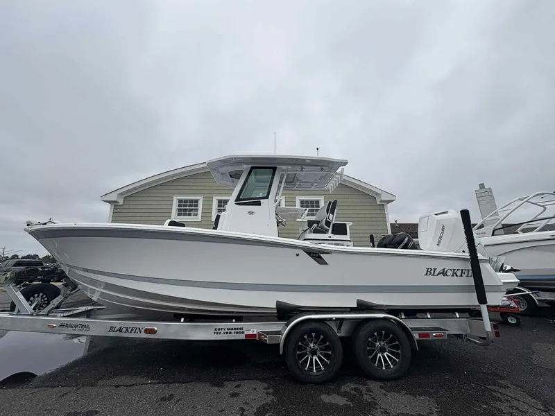 Slide: The Image of 2026 Blackfin 262 HB boat on trailer, parked outdoors under cloudy sky. - 20
