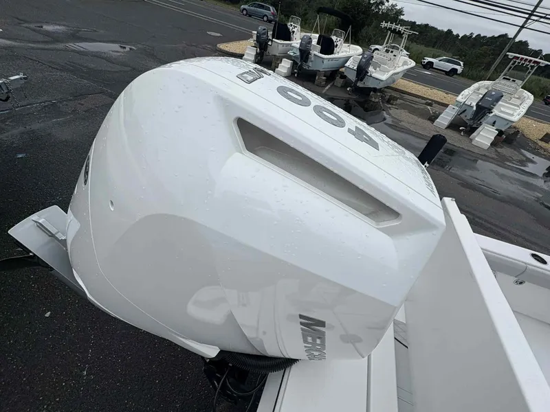 Slide: The Image of 2026 Blackfin 262 HB boat with powerful outboard motor in a marina setting. - 22