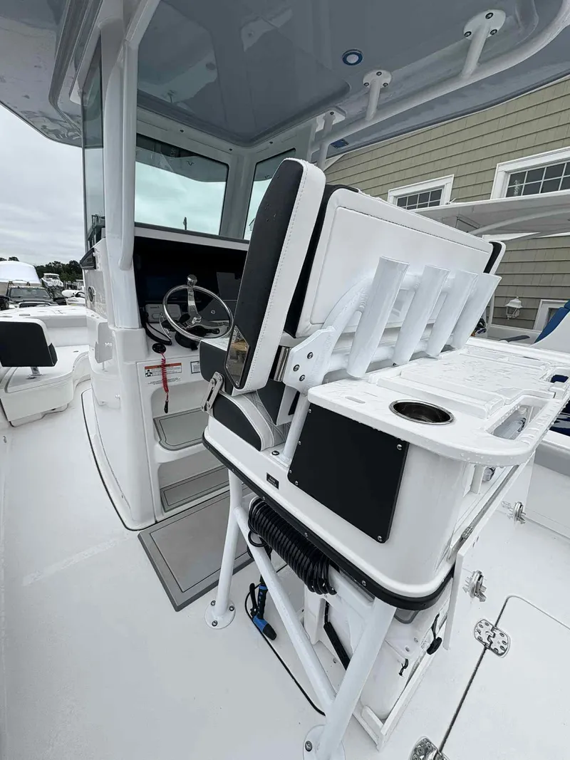 Slide: The Image of 2026 Blackfin 262 HB boat interior with steering wheel and seating area. - 3