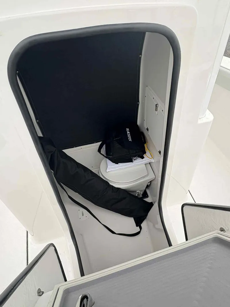 Slide: The Image of Interior of 2026 Blackfin 262 HB boat, featuring storage compartment and equipment. - 7