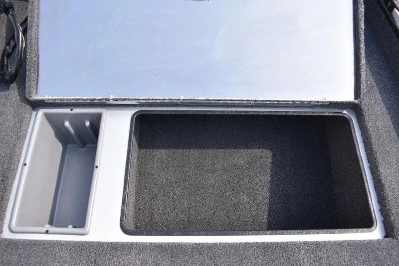 Slide: The Image of Open storage compartment in 2026 Lowe Skorpion 17 boat, featuring carpeted interior. - 16