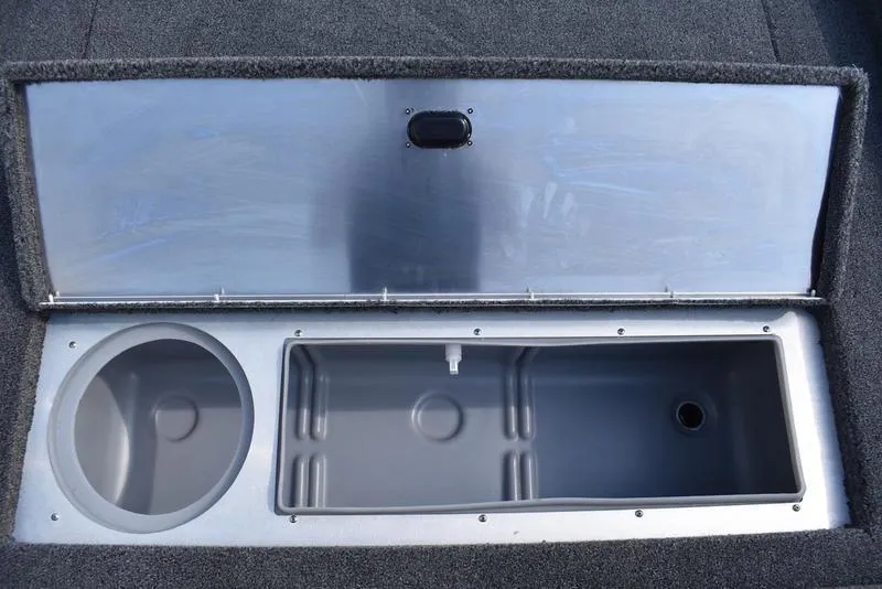 Slide: The Image of 2026 Lowe Skorpion 17 boat storage compartments with open lid, showcasing circular and rectangular spaces. - 17