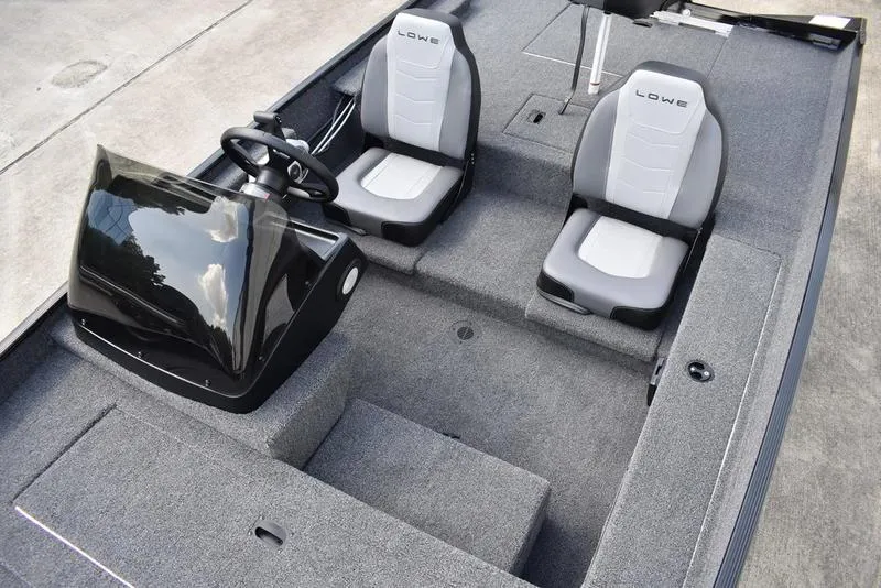 Slide: The Image of 2026 Lowe Skorpion 17 boat interior with dual seats and steering console. - 19