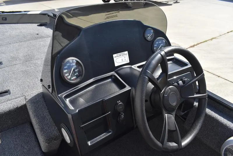 Slide: The Image of 2026 Lowe Skorpion 17 boat dashboard with steering wheel and gauges. - 22