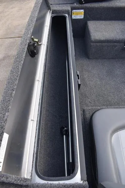 Slide: The Image of 2026 Lowe Skorpion 17 boat interior storage compartment with gray upholstery and carpeted finish. - 29