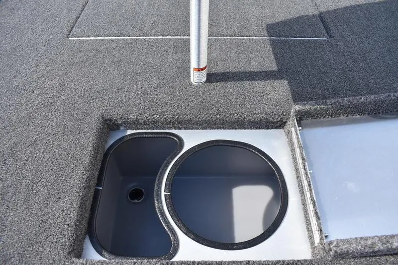 Slide: The Image of 2026 Lowe Skorpion 17 boat interior with open storage compartment and carpeted deck. - 32