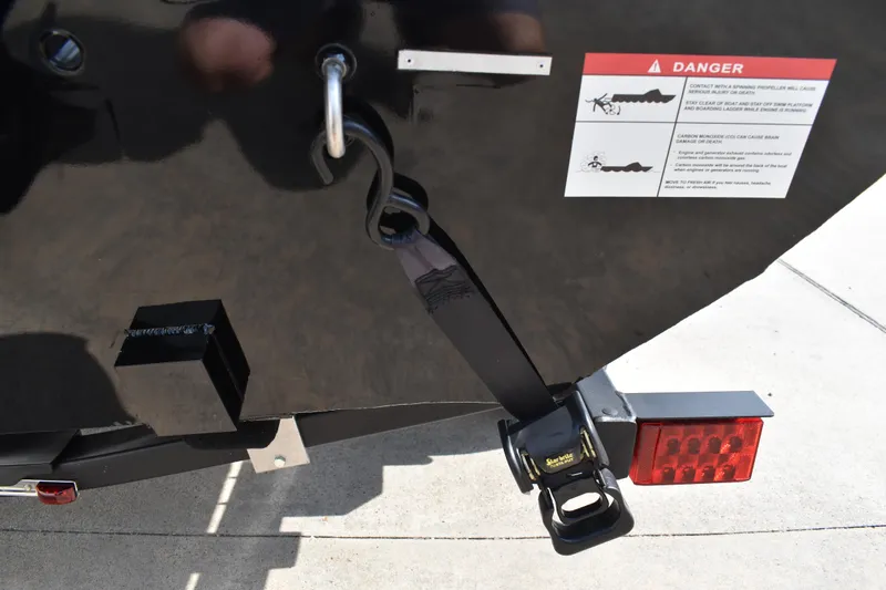 Slide: The Image of Rear view of 2026 Lowe Skorpion 17 boat with safety warning label and trailer hook. - 7