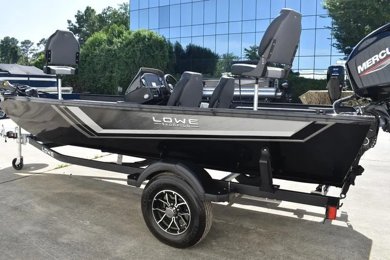 Slide: The Image of 2026 Lowe Skorpion 17 boat on trailer, sleek design, parked outdoors. - 9