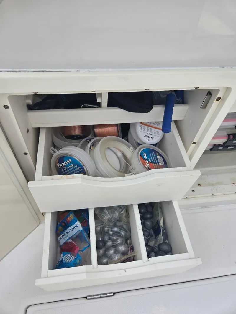 Slide: The Image of Fishing tackle storage on 2015 Jupiter 26 FS boat, featuring organized lines and weights. - 12