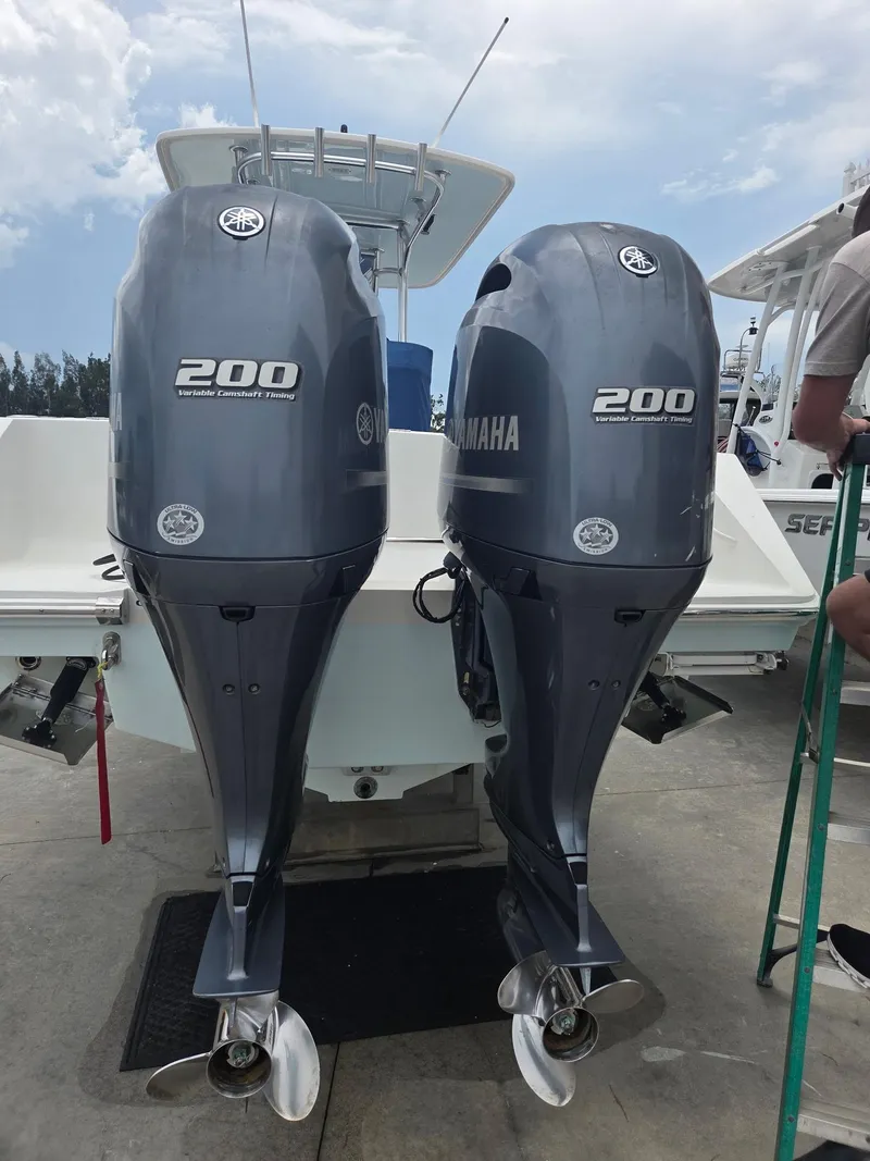 Slide: The Image of Twin Yamaha 200 outboard motors on a 2015 Jupiter 26 FS boat. - 14