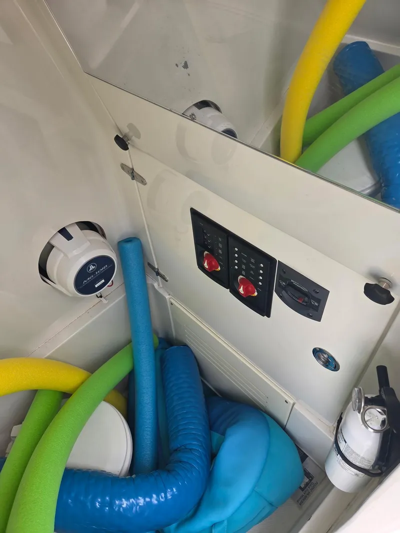 Slide: The Image of Interior of 2015 Jupiter 26 FS boat with pool noodles and control panel. - 18
