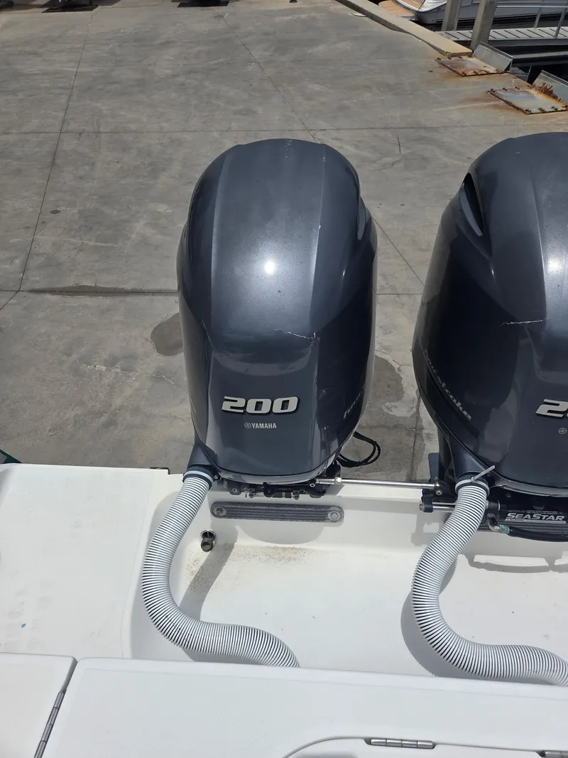Slide: The Image of Twin Yamaha 200 outboard motors on a 2015 Jupiter 26 FS boat. - 31