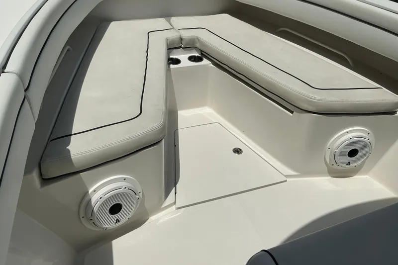 Slide: The Image of 2015 Jupiter 26 FS boat interior with cushioned seating and built-in speakers. - 36
