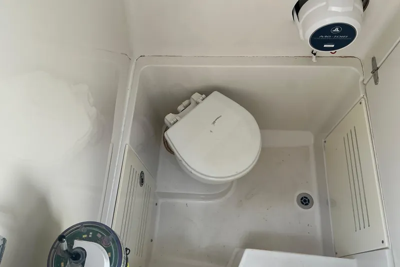 Slide: The Image of 2015 Jupiter 26 FS boat bathroom with toilet and storage compartments. - 38