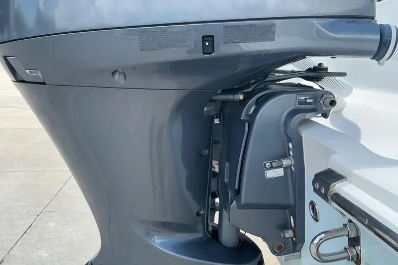 Slide: The Image of Close-up of a 2015 Jupiter 26 FS boat engine, showcasing its sleek design and components. - 44