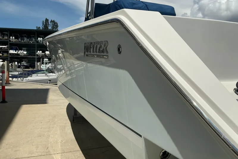 Slide: The Image of 2015 Jupiter 26 FS boat in marina, side view with logo visible. - 45