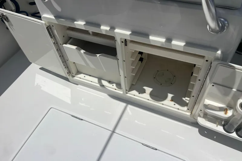 Slide: The Image of Open storage compartments on a 2015 Jupiter 26 FS boat deck. - 48
