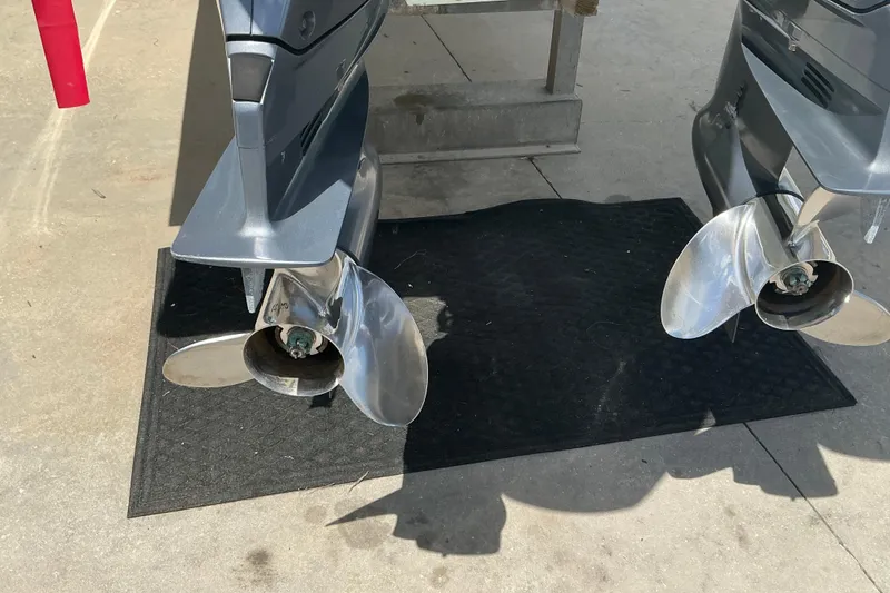 Slide: The Image of Twin propellers of a 2015 Jupiter 26 FS boat on a black mat. - 57