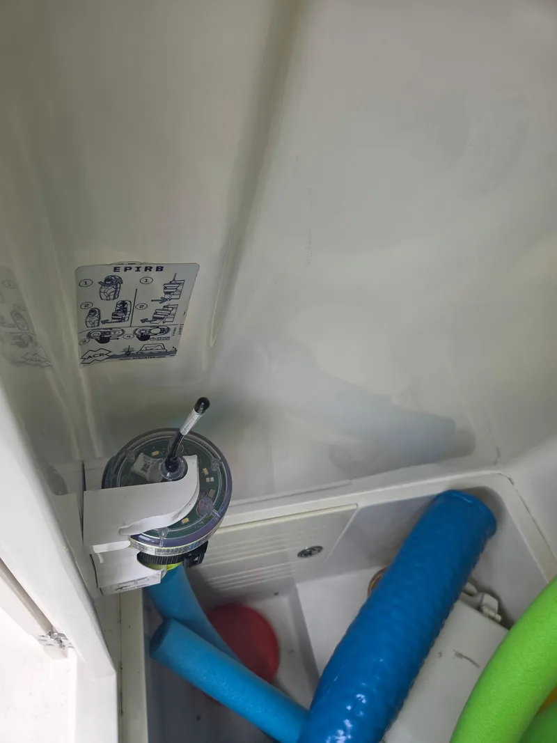 Slide: The Image of EPIRB installation in a 2015 Jupiter 26 FS boat, featuring blue and green hoses. - 7