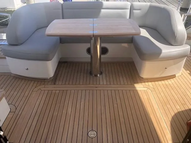 Slide: The Image of Luxurious seating area on 2016 Princess 52 Flybridge Yacht with wooden deck. - 11