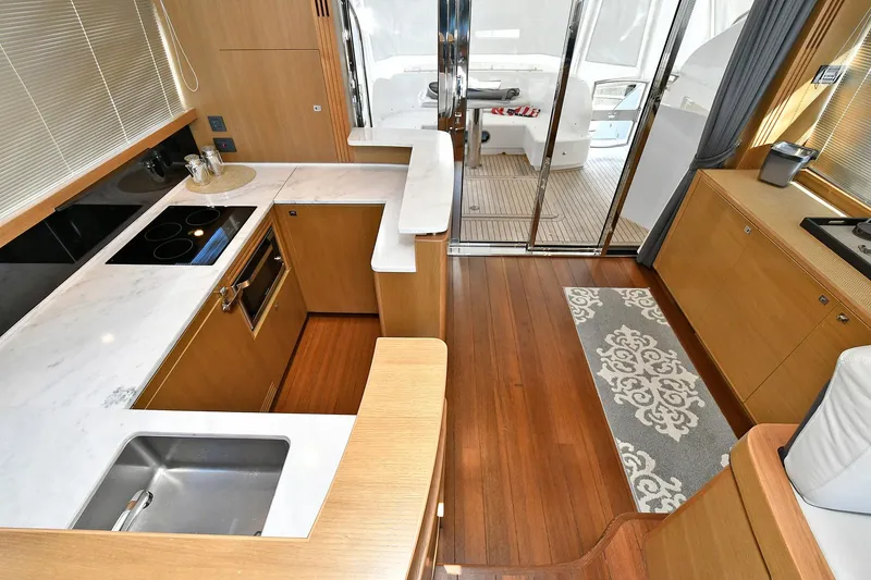 Slide: The Image of Luxurious kitchen interior of 2016 Princess 52 Flybridge Yacht with modern amenities and wooden flooring. - 15