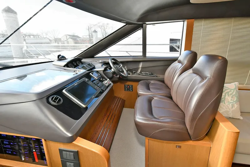 Slide: The Image of Interior of 2016 Princess 52 Flybridge Yacht with leather seats and modern dashboard. - 21