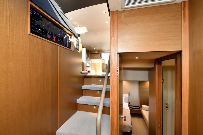Slide: The Image of Interior of 2016 Princess 52 Flybridge Yacht with wooden stairs and modern design. - 28