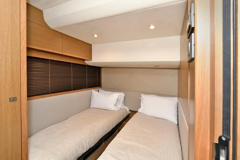Slide: The Image of Twin cabin interior of 2016 Princess 52 Flybridge Yacht, featuring modern design and cozy bedding. - 29