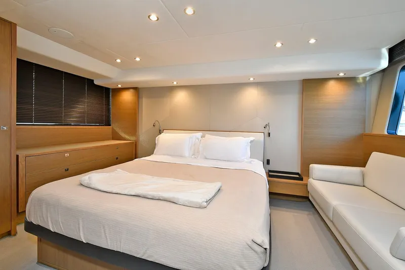 Slide: The Image of Luxurious bedroom interior on a 2016 Princess 52 Flybridge Yacht, featuring modern design and cozy ambiance. - 31