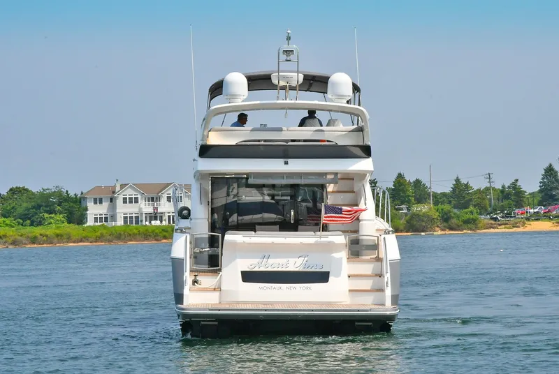 Slide: The Image of 2016 Princess 52 Flybridge Yacht on water near shoreline homes. - 6