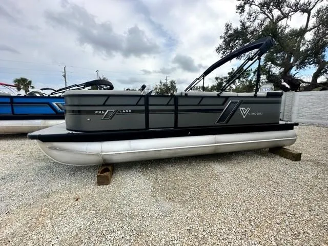 The Image of 2023 Viaggio Lago C pontoon boat on gravel lot under cloudy sky. - 1