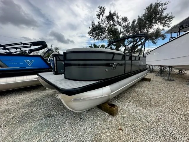 Slide: The Image of 2023 Viaggio Lago C pontoon boat on gravel lot, overcast sky. - 8