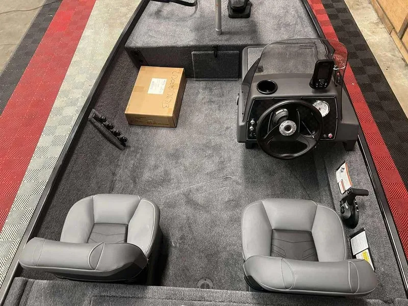 Slide: The Image of 2026 Tracker BASS TRACKER® Classic XL boat interior with steering console and seating. - 4