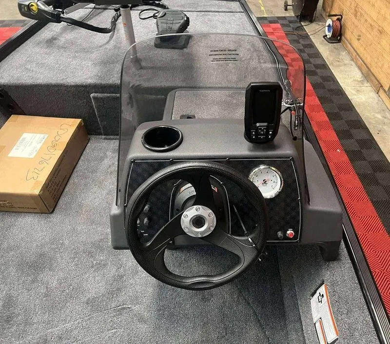 Slide: The Image of 2026 Tracker BASS TRACKER® Classic XL boat dashboard with steering wheel and navigation system. - 8