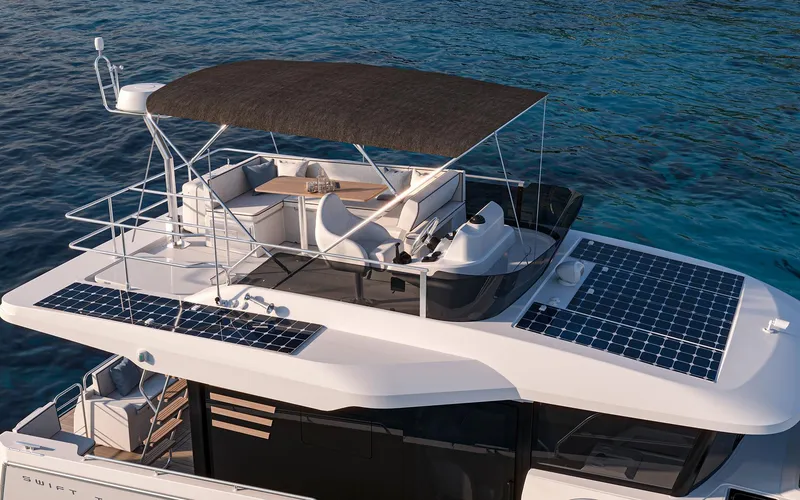 Slide: The Image of 2026 Beneteau 37 Swift Trawler with solar panels, flybridge, and ocean backdrop. - 4