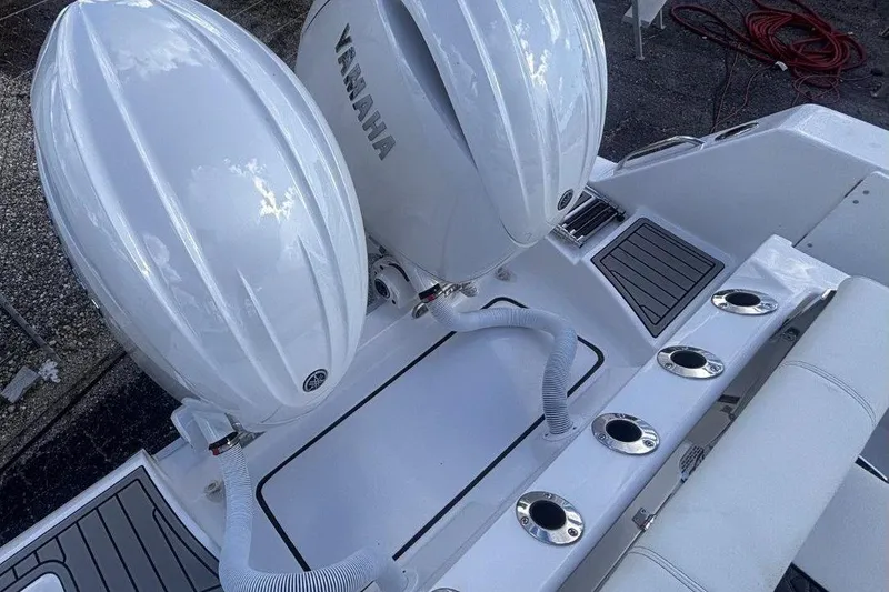 Slide: The Image of 2026 Tidewater 256 CC Adventure boat with dual Yamaha engines, rear deck view. - 11