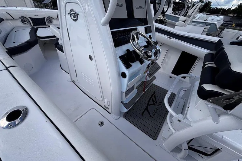 Slide: The Image of 2026 Tidewater 256 CC Adventure boat interior with steering console and seating. - 13