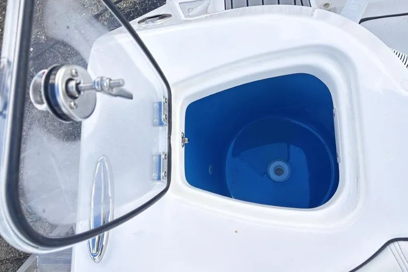 Slide: The Image of Open hatch of 2026 Tidewater 256 CC Adventure boat, showing interior compartment. - 17