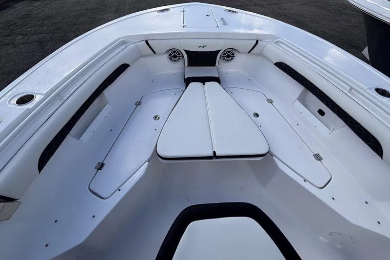 Slide: The Image of 2026 Tidewater 256 CC Adventure boat interior with white seating and storage compartments. - 34
