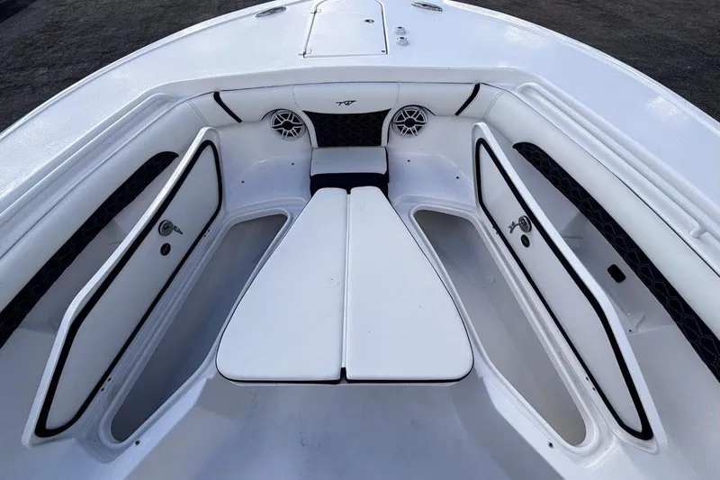 Slide: The Image of 2026 Tidewater 256 CC Adventure boat interior with seating and storage compartments. - 35