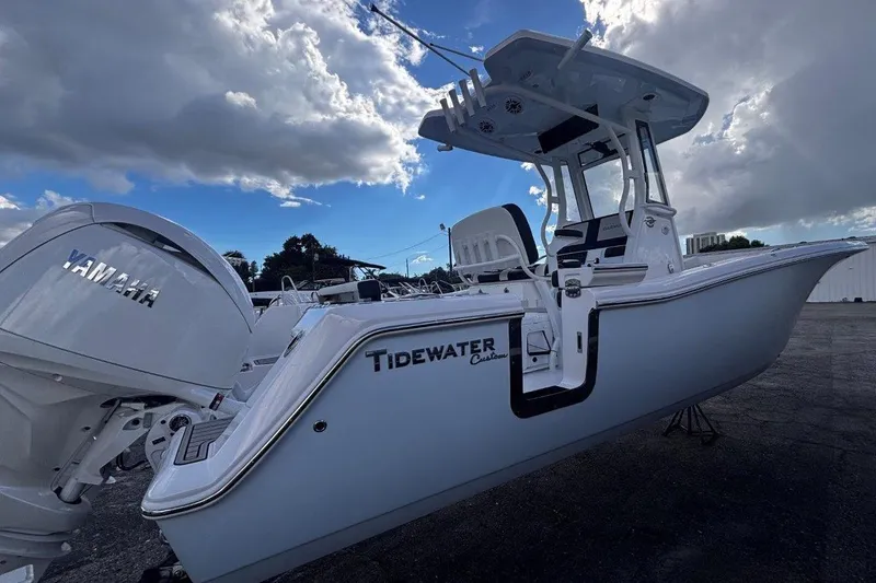 Slide: The Image of 2026 Tidewater 256 CC Adventure boat with Yamaha engine under cloudy sky. - 6