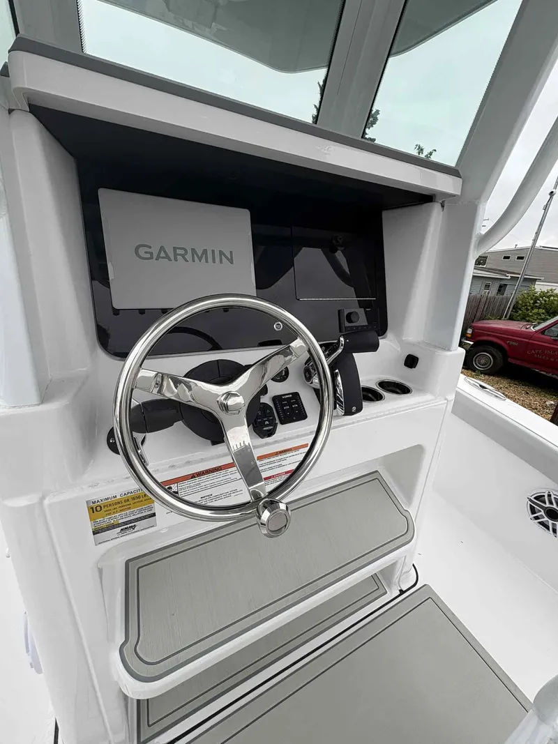 Slide: The Image of 2026 Blackfin 242HB boat helm with Garmin navigation system and sleek steering wheel. - 10
