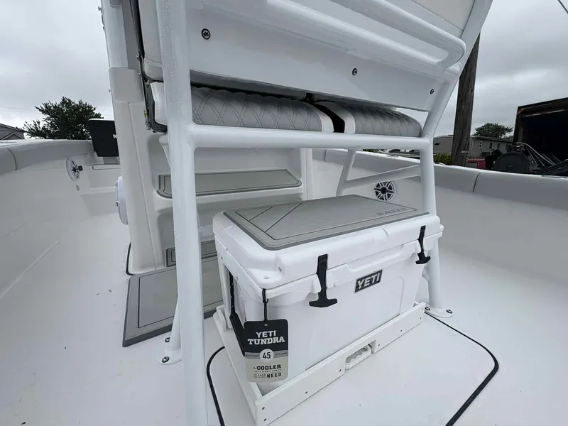 Slide: The Image of 2026 Blackfin 242HB boat interior with Yeti Tundra cooler and cushioned seating. - 11