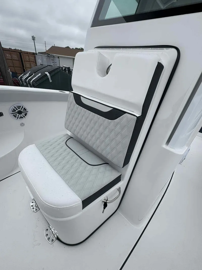 Slide: The Image of 2026 Blackfin 242HB boat seat with quilted design and storage compartment. - 13